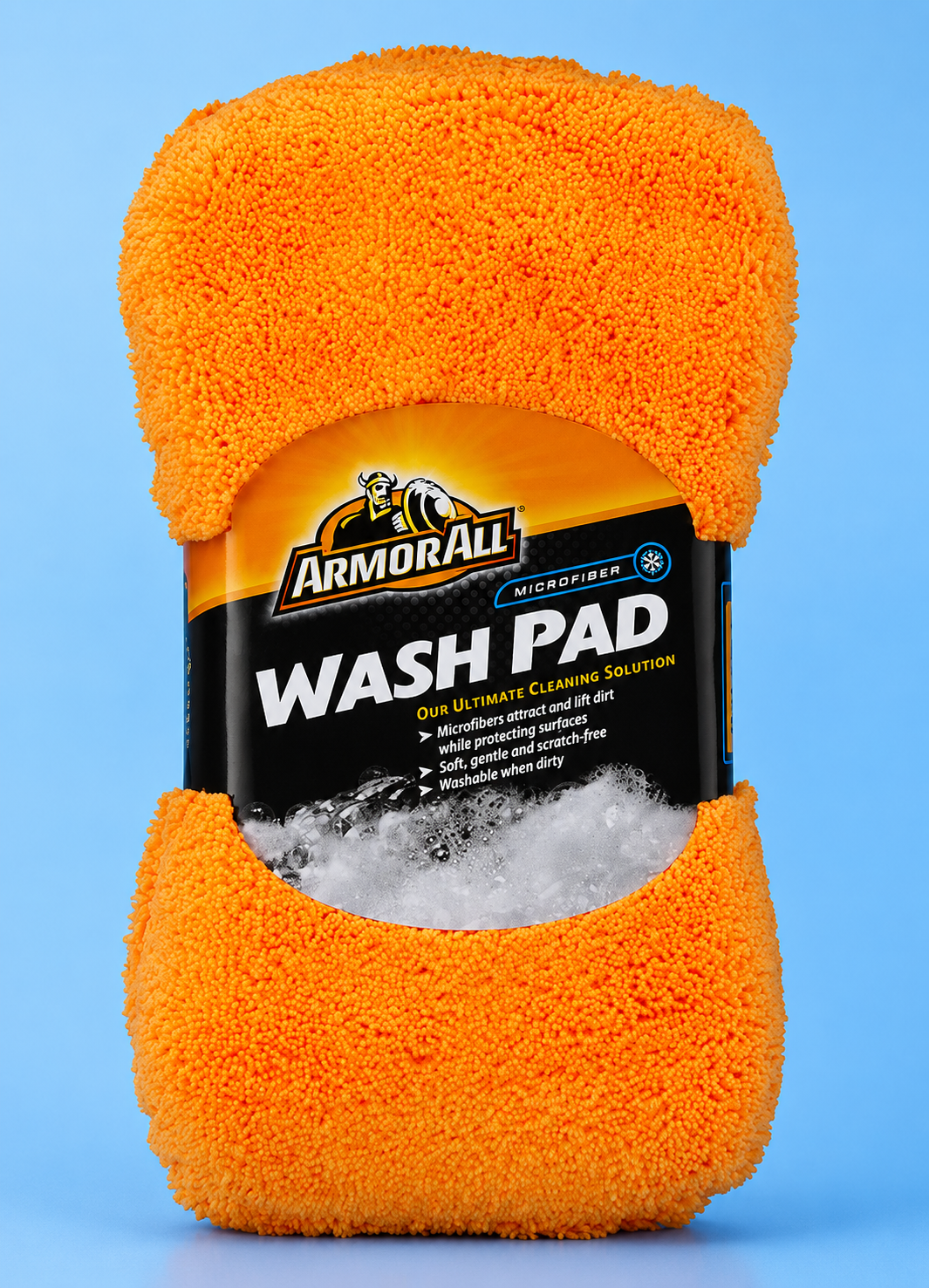 An orange Armor All microfiber car wash pad with its product packaging sleeve centered against a solid blue background.