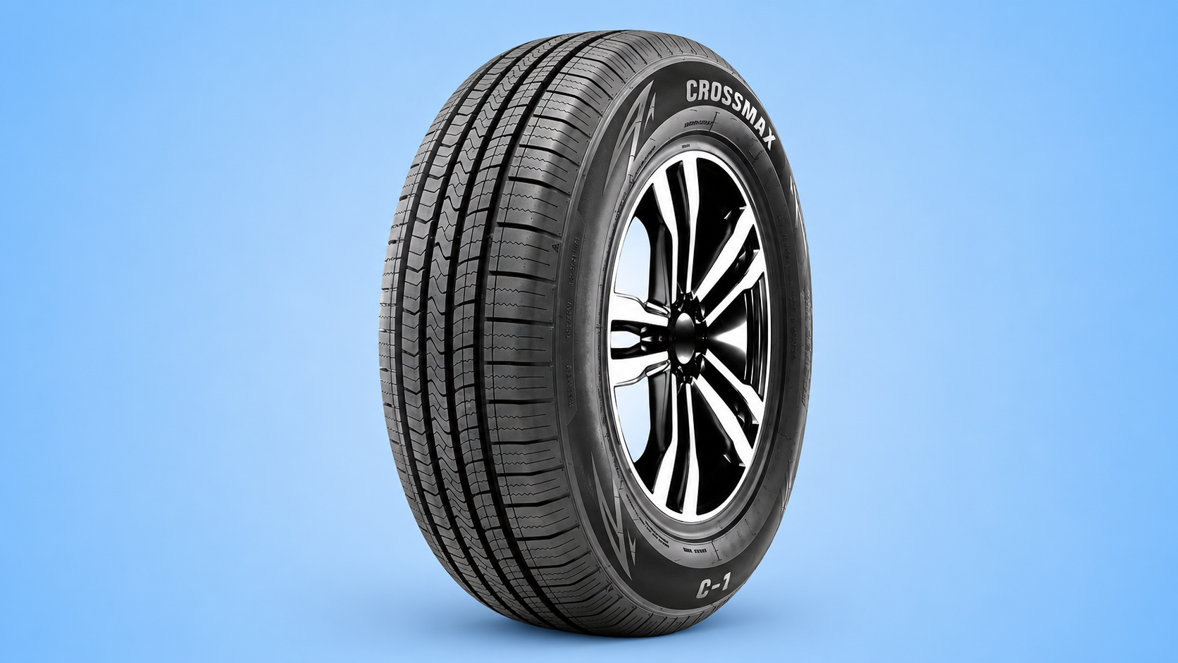 A Crossmax C-1 car tire mounted on a black and silver rim against a blue background.