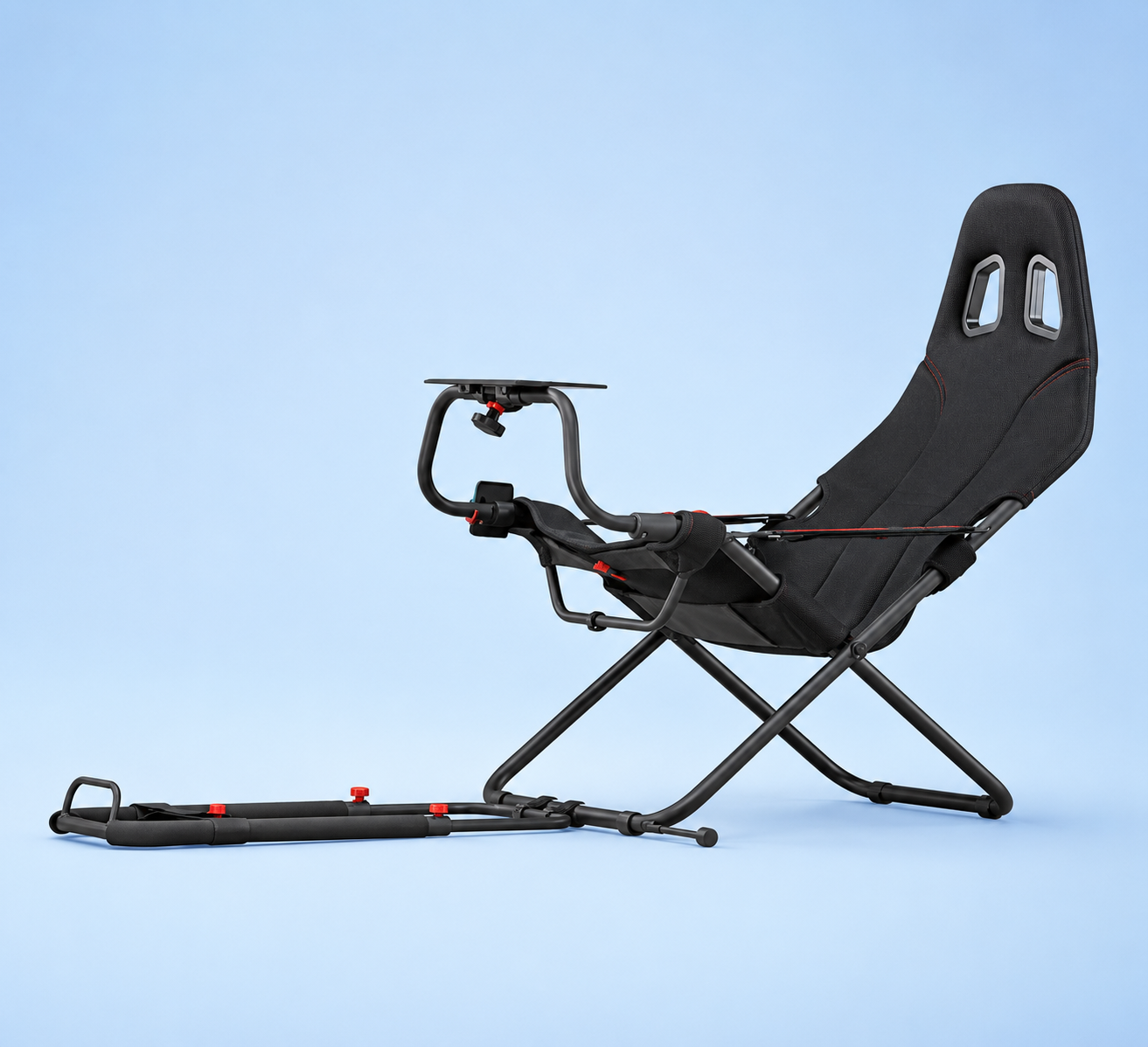 A foldable black racing simulator cockpit chair with an attached steering wheel stand and pedal base extension, set against a solid blue background.