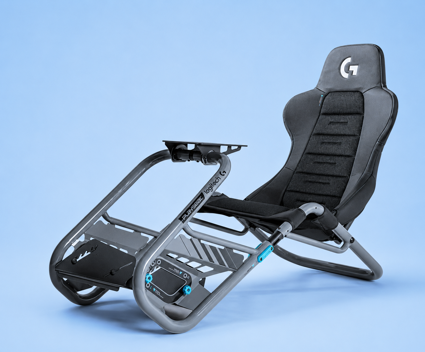 A gray and black Playseat Challenge X Logitech G Edition racing simulator cockpit chair with integrated wheel and pedal mounts, set against a solid blue background.