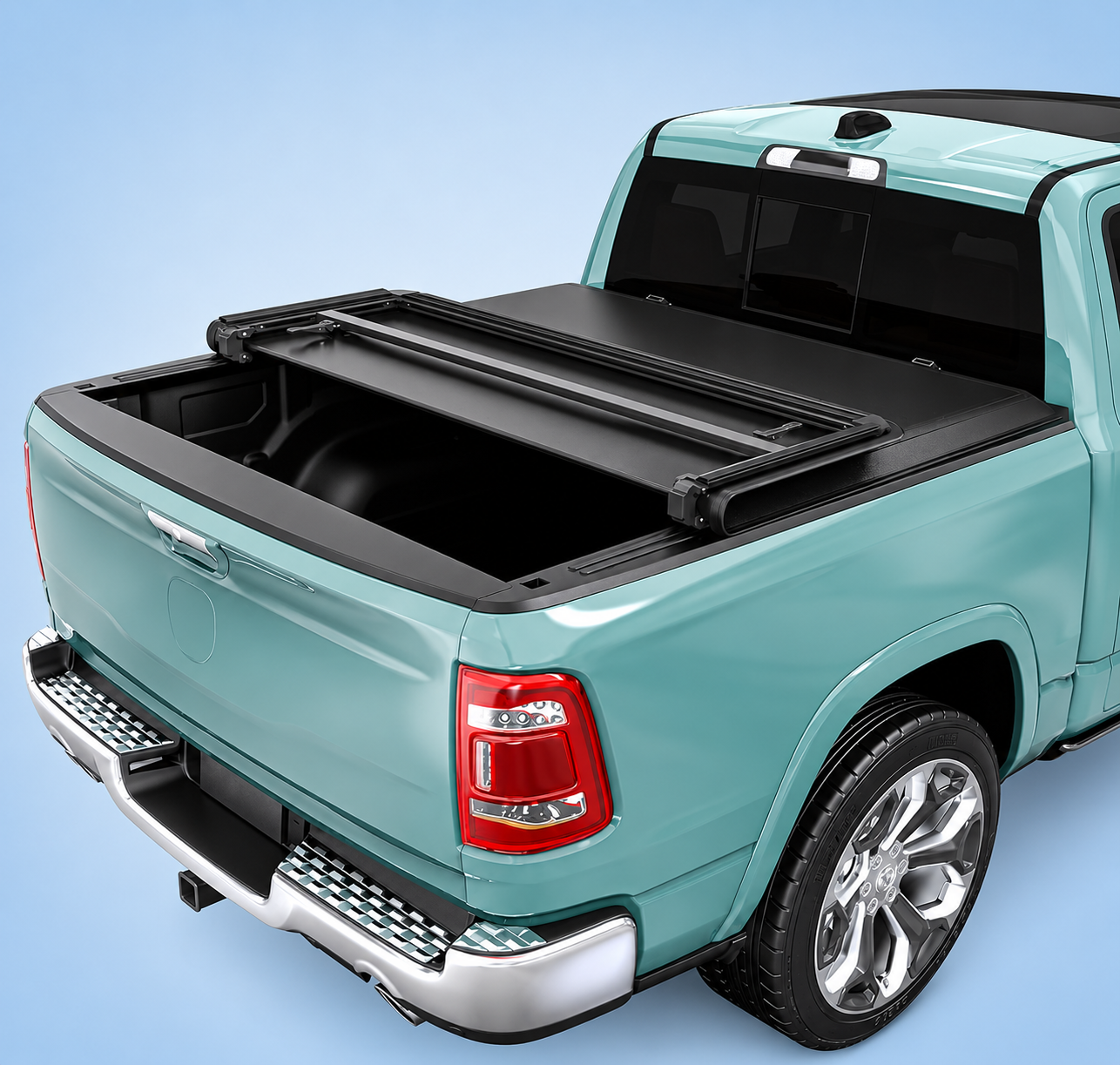 A teal Ram 1500 truck with a black tonneau cover partially folded open on a blue background.