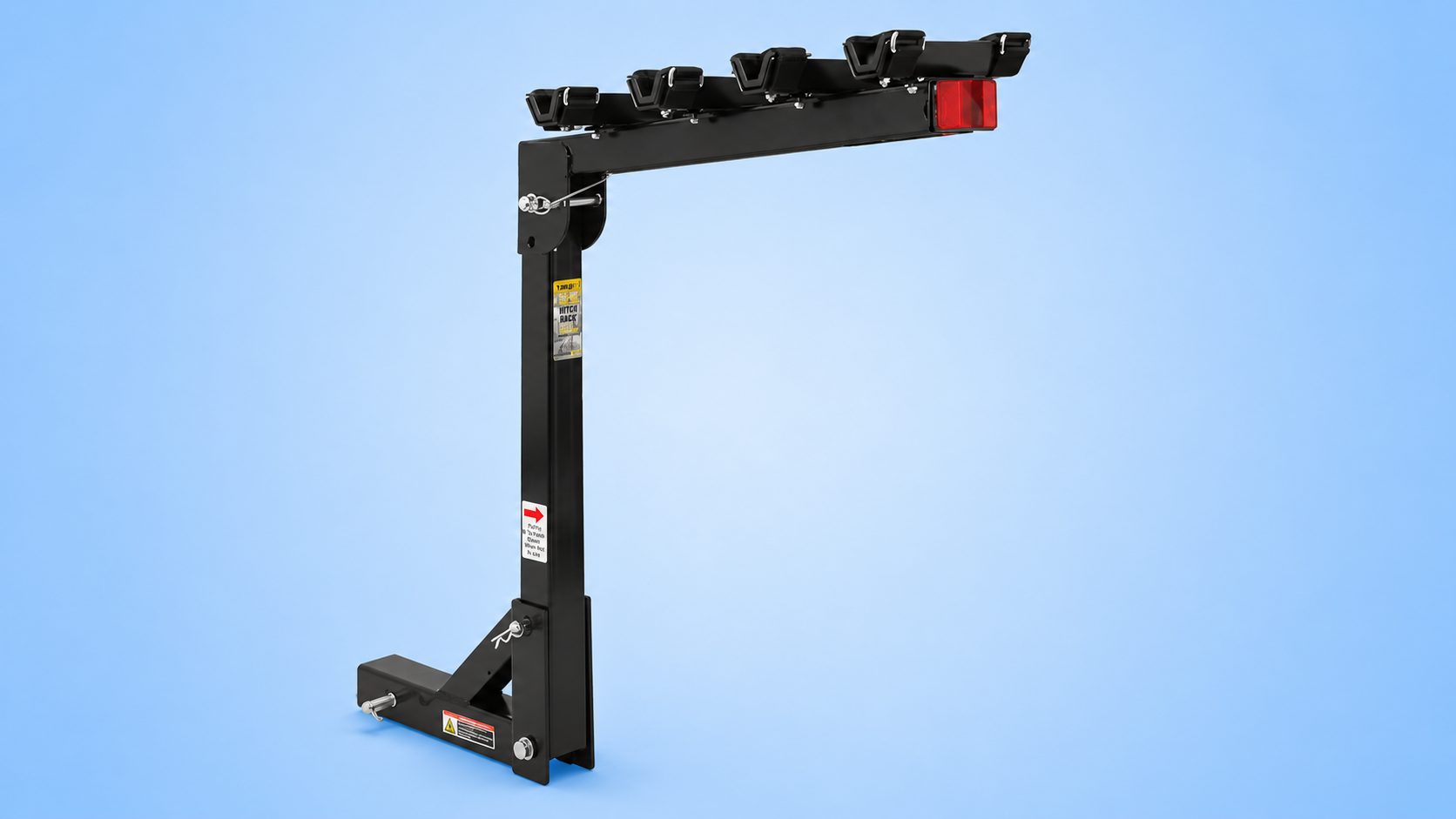 A black Tyger Auto hitch-mounted 4-bike rack with cradles and a red reflector on the end arm against a blue background.