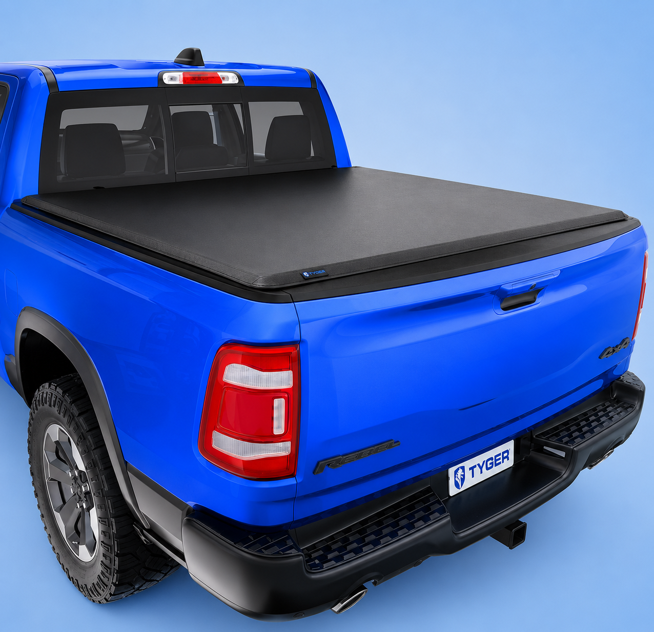 Tyger Auto T3 soft tri-fold tonneau cover installed on a blue truck.