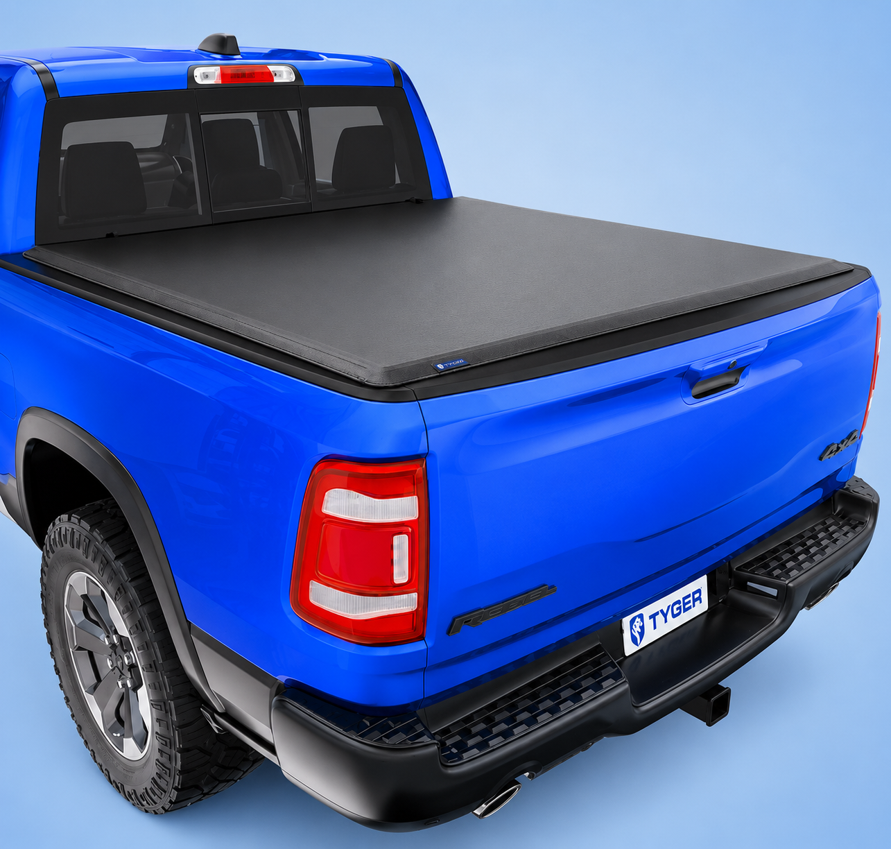 A blue Ram 1500 truck equipped with a closed Tyger tonneau cover on a blue background.