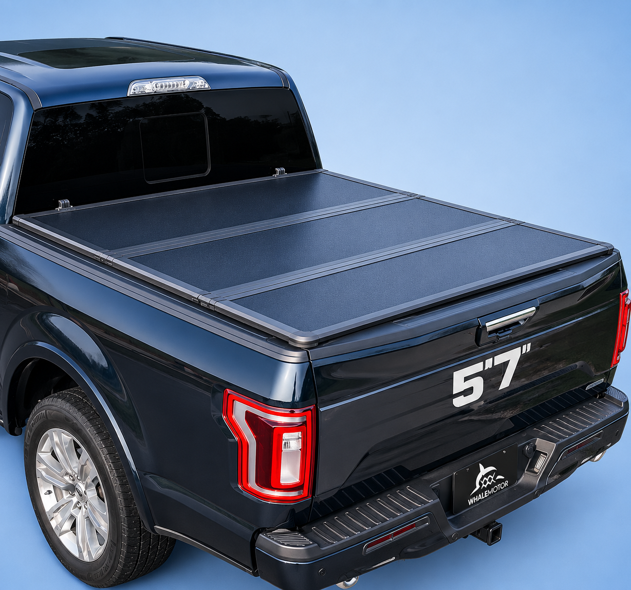 Whalemotor hard quad-fold tonneau cover on a dark truck bed.