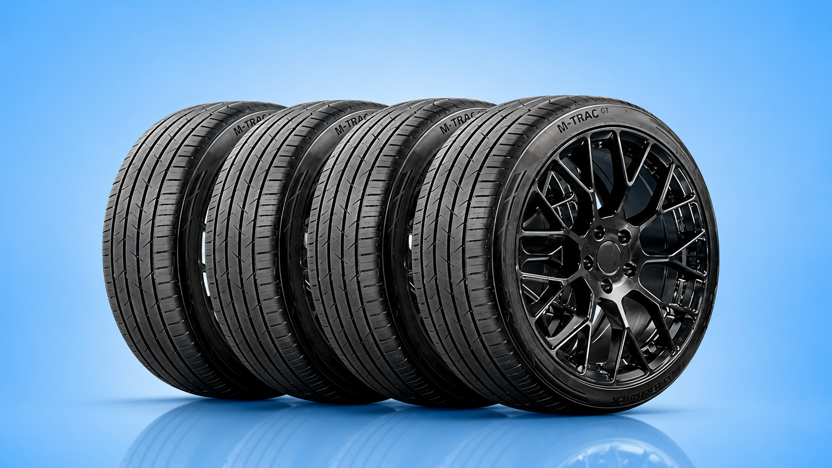 Set of four M-Trac GT high-performance car tires lined up against a solid blue background.
